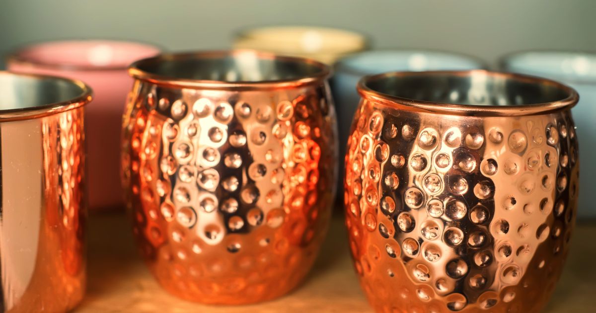 a group of copper mugs